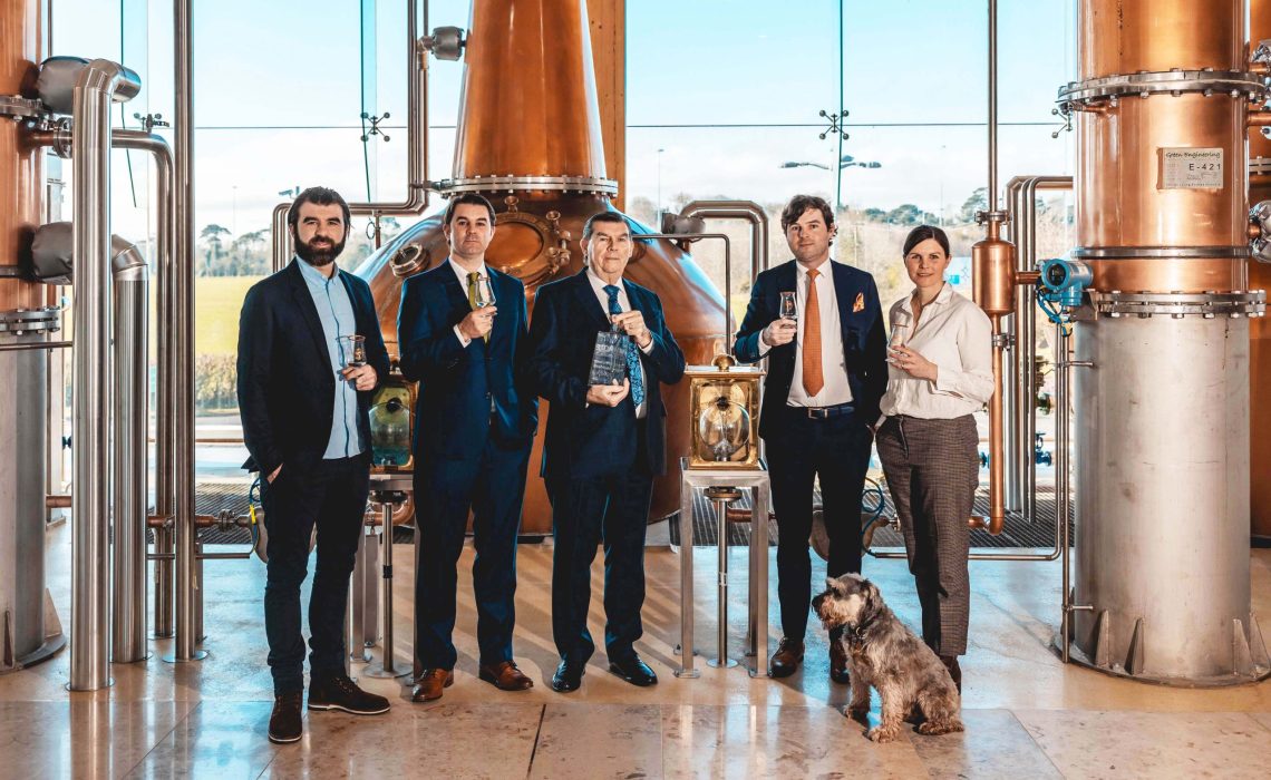 Paddy Cooney (left), with Peter Cooney, Pat Cooney, founder, James Cooney and Sally Anne Cooney celebrate the world's Best New Make award, earlier this year, alongside Max the dog.