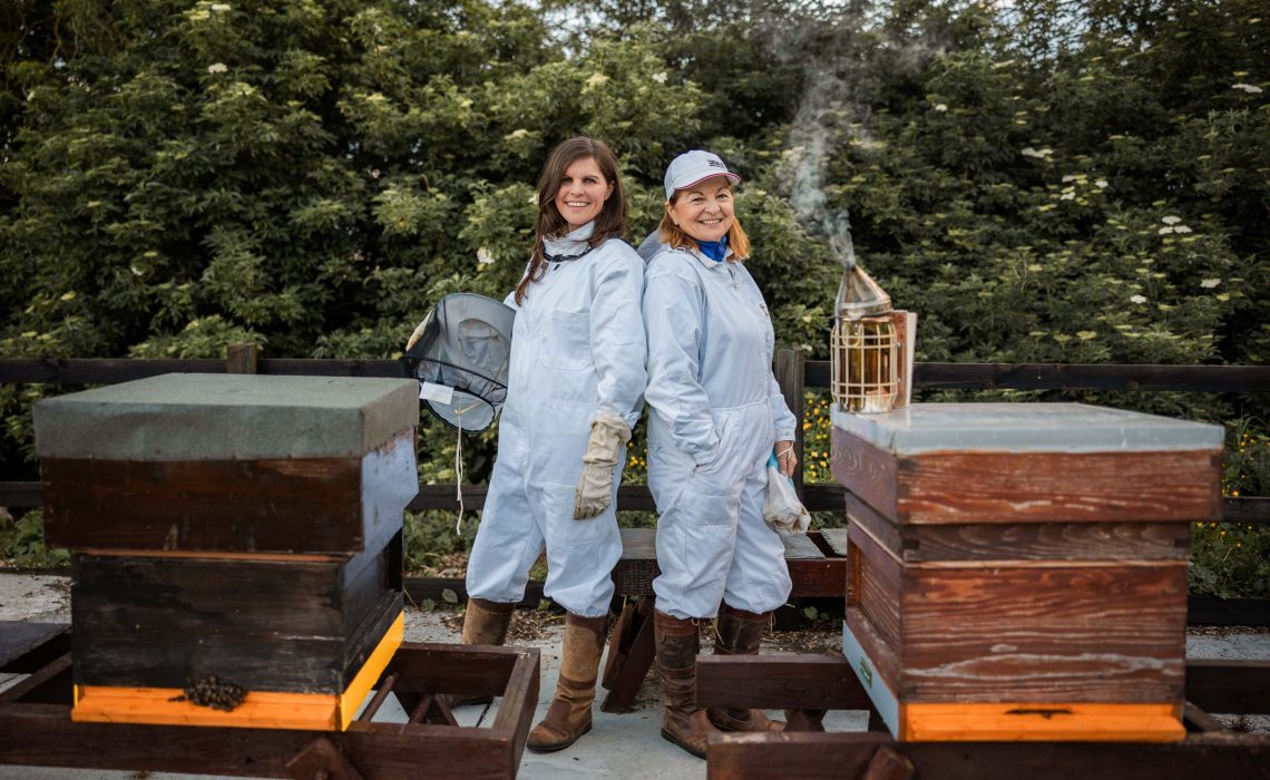 Sally Anne Cooney, left, with her mother Marie Cooney, with some of the beehives at the family's lands in Kilmessan, Co Meath.  The enterprising mother and daughter are taking on the spirit world with Silks Gin – named after the jockeys’ silks worn at the famous Bellewstown racecourse in Meath beside the family’s Boann Distillery.